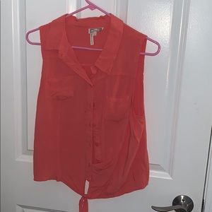 orange sleeveless, button down blouse